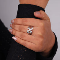 Hand wearing a silver ring with a diamond on a gray background, Modern Multi Layer Round Moissanite Ring – Bubble Bezel Set Wedding Jewelry