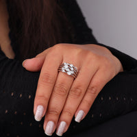 Hand wearing a silver ring with a black background, Round Cut Moissanite Bubble Bezel Ring – Multi Layer Stackable Wedding Band