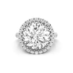 Diamond ring with a large central gemstone and smaller diamonds around on a white background