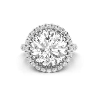 Diamond ring with a large central gemstone and smaller diamonds around on a white background
