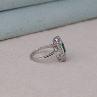 Silver ring with emerald and diamonds on a light surface, 14K Gold Art Deco CZ Bridal Jewelry, Retro Green CZ Wedding Band For Bride, Vintage Green CZ Engagement Ring With Detailing