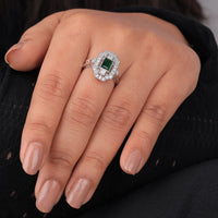 Close-up of a hand wearing an emerald and diamond ring against a black background, Intricate Art Deco Design Bridal Ring, Elegant Green CZ Anniversary Ring, Unique Vintage Style CZ Wedding Jewelry