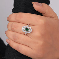 Hand wearing a ring with a green gemstone and diamond accents on a neutral background, Green Cubic Zirconia Bridal Jewelry, Classic Art Deco Wedding Band, Affordable Vintage Green CZ Promise Ring