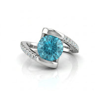 Silver ring with a blue gemstone on a white background
