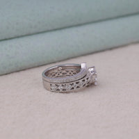 Silver ring with diamond accents on a light gray surface, Art Deco Vintage Bridal Ring Set – Round and Marquise Moissanite Wedding Bands