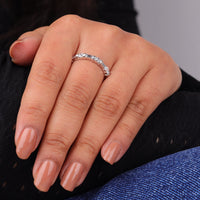 Hand wearing a silver ring with a blurred background, Dot Dash Eternity Wedding Band, Elegant Moissanite Anniversary Ring, Unique Moissanite Eternity Jewelry