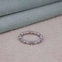 Silver ring with embedded stones on a textured surface, Moissanite Half Eternity Anniversary Band, Symbolic Eternity Wedding Ring