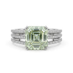 Asscher cut moissanite engagement ring with light green center stone, split shank pavé band, and elegant statement design
