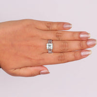 Asscher cut moissanite engagement ring with light green center stone, split shank pavé band, and elegant statement design