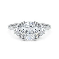 Cushion cut cubic zirconia three stone engagement ring with half moon side stones in a classic prong setting