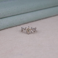 Nature-inspired vine ring featuring a kite cut cubic zirconia center stone with round accent stones and botanical leaf detailing