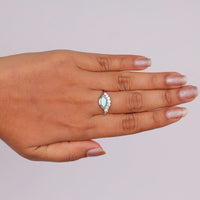 Ocean Bloom marquise cut aqua blue moissanite crown ring with round accent stones in a nature-inspired wave design