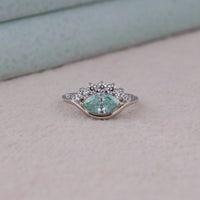 Ocean Bloom marquise cut aqua blue moissanite crown ring with round accent stones in a nature-inspired wave design