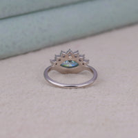 Ocean Bloom marquise cut aqua blue moissanite crown ring with round accent stones in a nature-inspired wave design