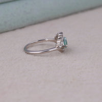 Ocean Bloom marquise cut aqua blue moissanite crown ring with round accent stones in a nature-inspired wave design