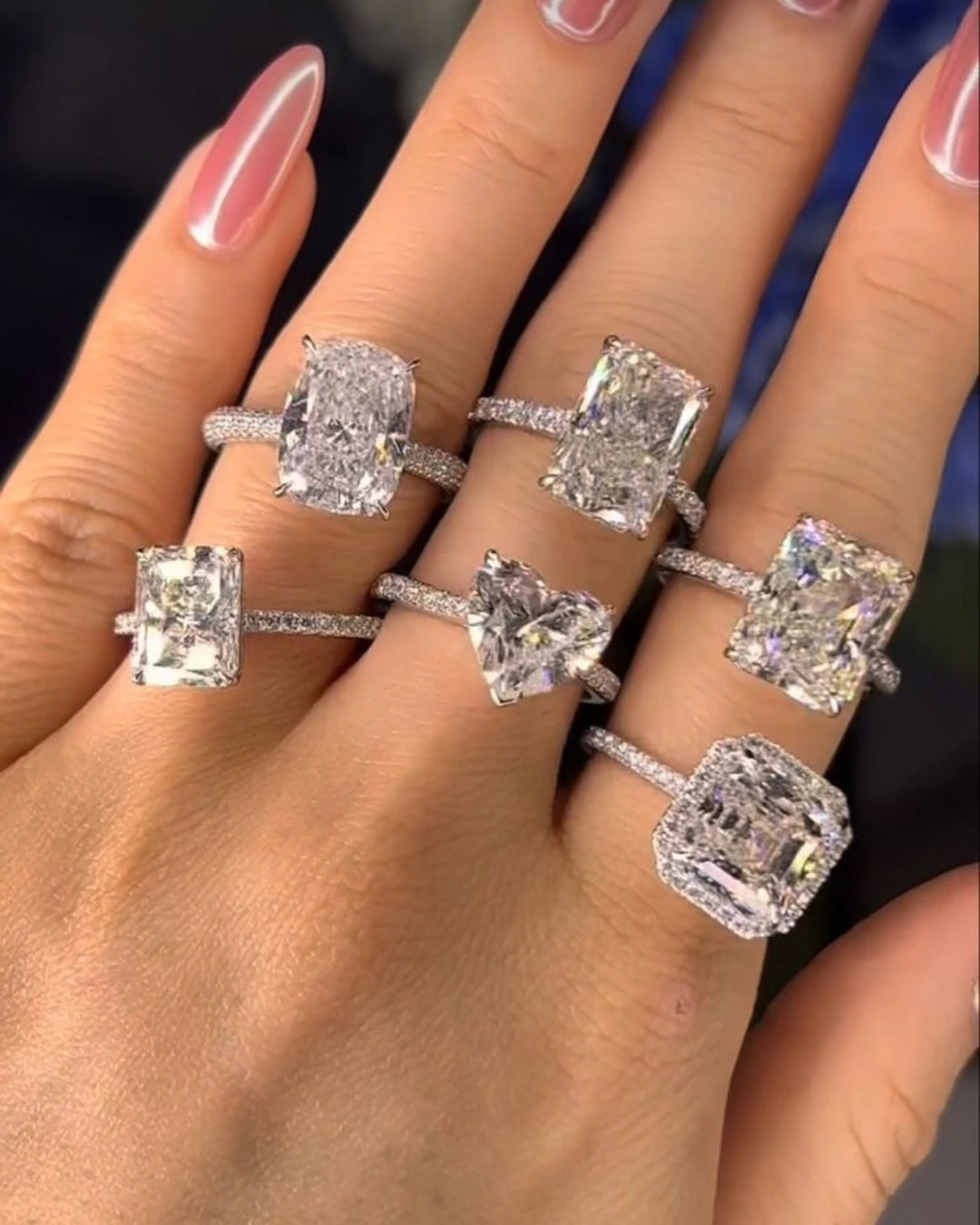 Lab-grown diamond engagement rings worn on a hand