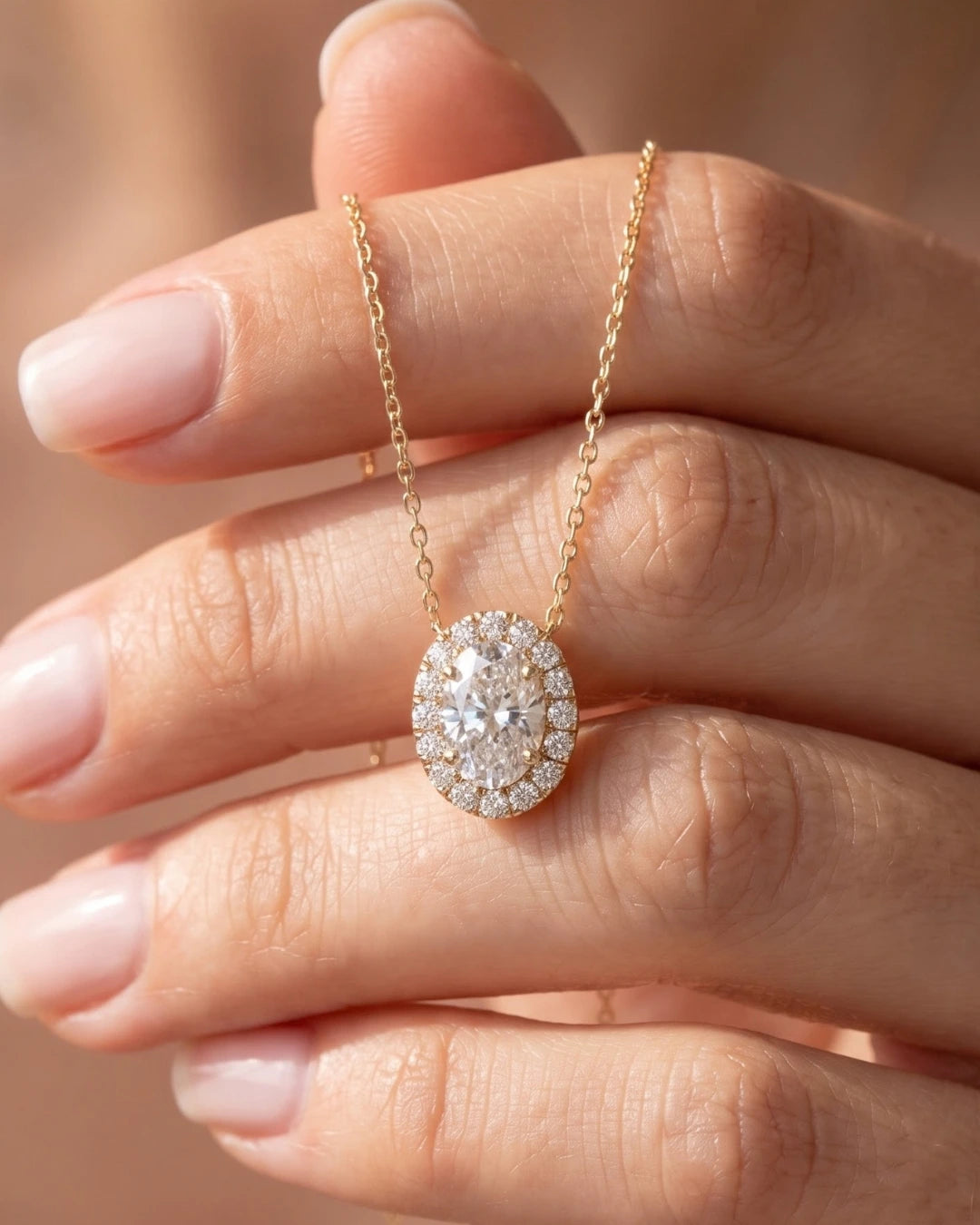 Lab-grown diamond pendant necklace held in a hand