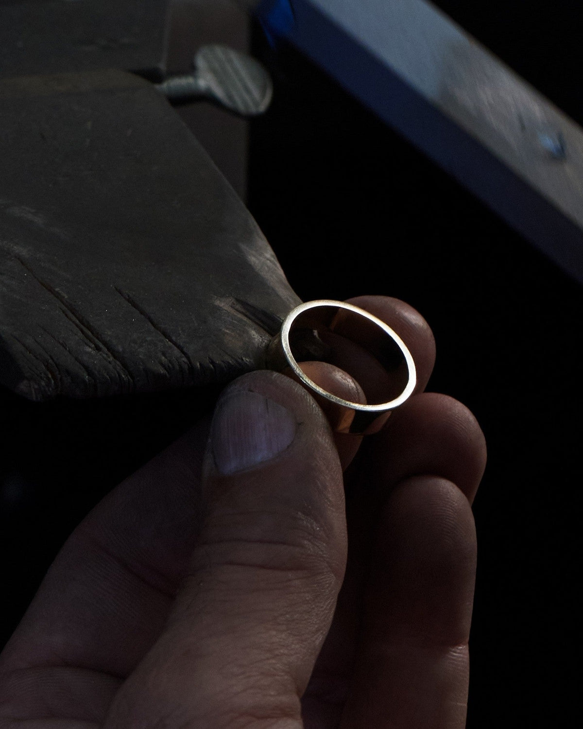 Jeweler holding a ring at the workbench