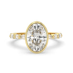 Oval bezel set lab grown diamond pave engagement ring with 3.50 carat center diamond in yellow gold