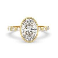 Oval bezel set lab grown diamond pave engagement ring with 3.50 carat center diamond in yellow gold