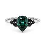 metalcolor:white Pear cut green moissanite accent stone engagement ring with round black side stones in a prong setting