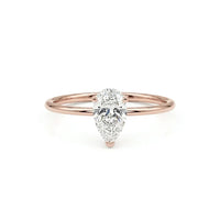 metalcolor:rose Pear cut moissanite solitaire engagement ring with clear center stone in prong setting and minimalist band design
