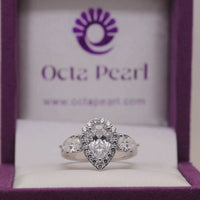 Pear Cut Moissanite Halo Engagement Ring With Side Stones