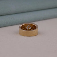 Men's princess cut Moissanite halo ring with wide geometric pavé band and statement luxury design in yellow tone metal.