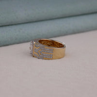 Men's princess cut Moissanite halo ring with wide geometric pavé band and statement luxury design in yellow tone metal.