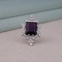 Purple baguette cut CZ statement ring with round cut accent stones and floral-inspired luxury design