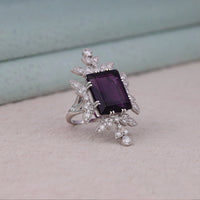 Purple baguette cut CZ statement ring with round cut accent stones and floral-inspired luxury design