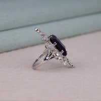 Purple baguette cut CZ statement ring with round cut accent stones and floral-inspired luxury design