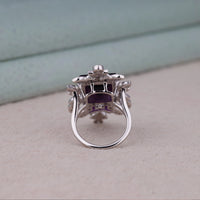 Purple baguette cut CZ statement ring with round cut accent stones and floral-inspired luxury design