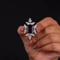 Purple baguette cut CZ statement ring with round cut accent stones and floral-inspired luxury design