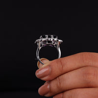 Purple baguette cut CZ statement ring with round cut accent stones and floral-inspired luxury design