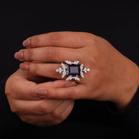 Purple baguette cut CZ statement ring with round cut accent stones and floral-inspired luxury design