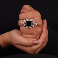 Purple baguette cut CZ statement ring with round cut accent stones and floral-inspired luxury design