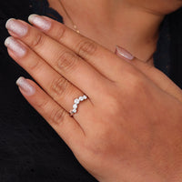Round cut five stone moissanite curved ring with prong setting and elegant crown-inspired design