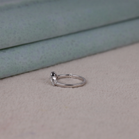 Round cut five stone moissanite curved ring with prong setting and elegant crown-inspired design