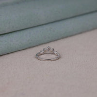 Round cut five stone moissanite curved ring with prong setting and elegant crown-inspired design
