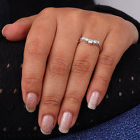 Round cut five stone moissanite curved ring with prong setting and elegant crown-inspired design