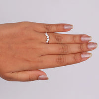 Round cut five stone moissanite curved ring with prong setting and elegant crown-inspired design