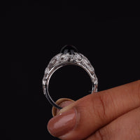 Vintage filigree statement ring featuring deep blue cabochon center stone with round accent stones and intricate scrollwork design