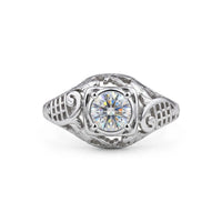 Vintage filigree engagement ring featuring a 5.00 mm round cut moissanite center stone in a decorative prong setting with intricate openwork design