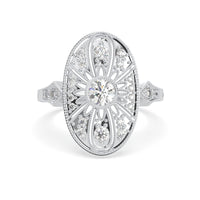 Vintage oval statement ring featuring round moissanite center stone, halo-inspired detailing, and intricate openwork luxury design