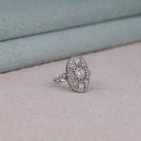 Vintage oval statement ring featuring round moissanite center stone, halo-inspired detailing, and intricate openwork luxury design