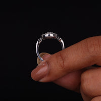 Vintage oval statement ring featuring round moissanite center stone, halo-inspired detailing, and intricate openwork luxury design