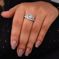 Vintage round cut moissanite bezel ring with 1.00 carat center stone, milgrain detailing, halo accents, and antique-inspired design